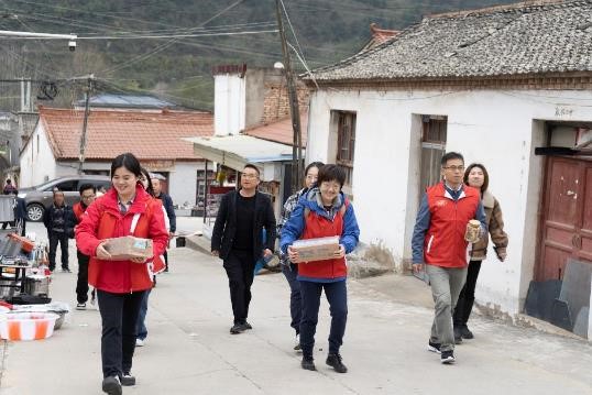 维他奶员工志愿者带着营养豆奶、坚果、护眼灯等“健康大礼包”，走访部分学生家庭。